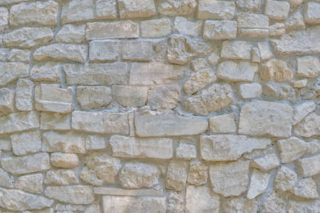 Background of an old wall made of large rockの写真素材