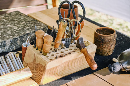 Retro shoemaker tools, close-up. Vintage leather working toolkit.