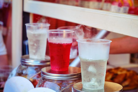 Sale of cold drinks in a street shop. Soda in plastic cups on the counter of the city cafe. Drinks...