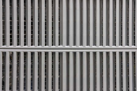 Gray metal surface with a two-part grid, backgroundの写真素材