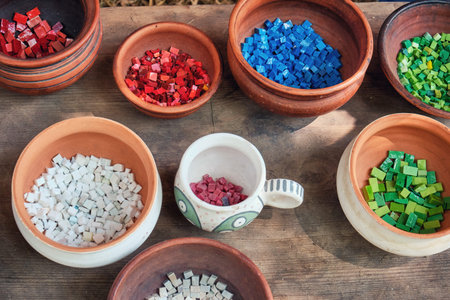 Retro mosaic cubes in clay pots. Creating patterns from processed stones. The material for...