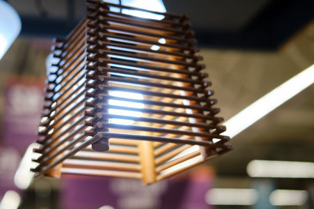 Wooden chandelier made of slats with a lamp inside