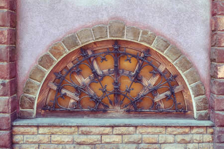 The old semicircular window with bars. Wooden window made in half circle. and stoned.の写真素材