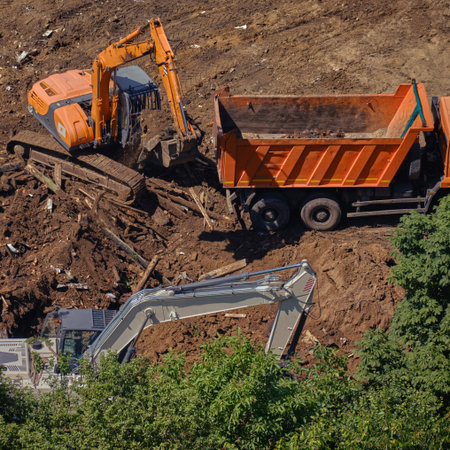 Bulldozers and truck in the park, top view on construction in the forest