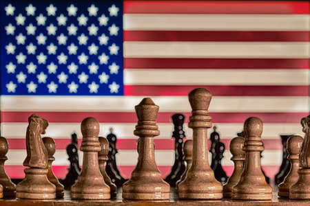 American flag on the background of a chessboard with piecesの写真素材