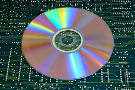 Cd drive against electronic circuit boardの写真素材