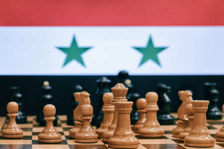 Flag of Iran on the background of a chessboard with piecesの写真素材