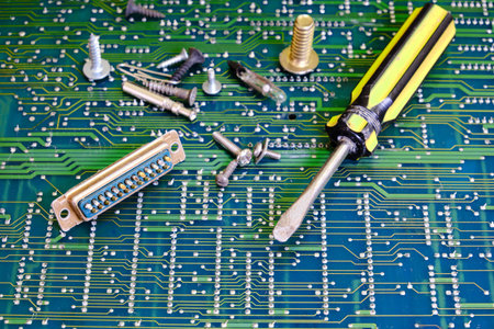 Screwdriver for electronics repair against circuit board