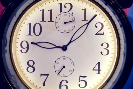 White dial of a large watch with black numerals