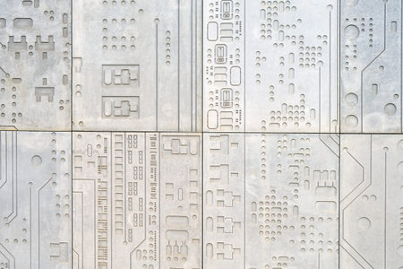 Concrete wall background with a print of a computer chip, modern electronics in stone
