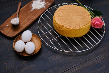 Flour and eggs for cooking sponge cake on black wooden background, copy spaceの写真素材