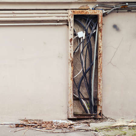 Exposed electrical wires on the facade houseの写真素材