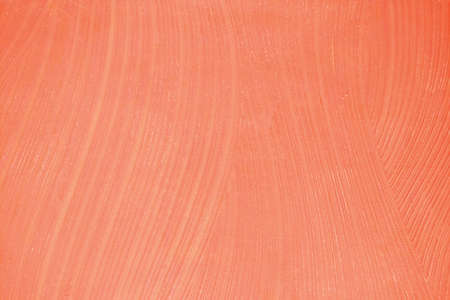 Surface background with smears of orange paint, close-up textureの写真素材