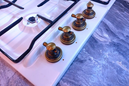 Modern gas stove with antique switches, vintage handles