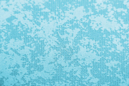 Texture inhomogeneously painted light blue wall background