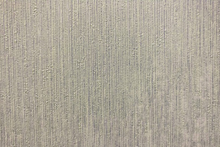 Texture with drops of gray paint on uneven surface, background close-up