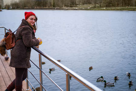 Portrait woman in a winter park near the waterの写真素材