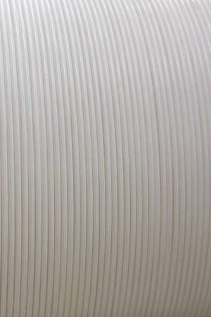 Close-up of ablazed white corrugated plastic surfaceの写真素材