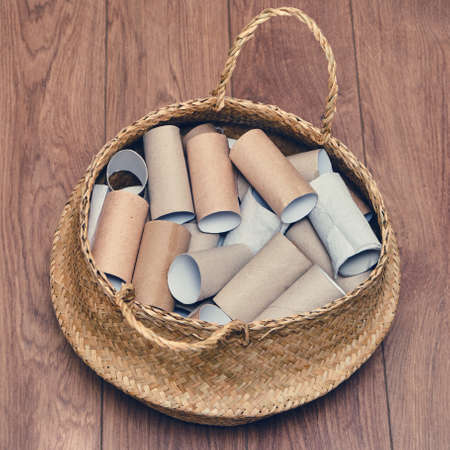 A lot of empty rolls of toilet paper lies in a basket. Concept of paper recycling and reuseの写真素材