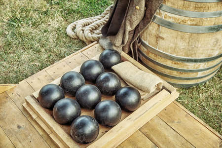 Cannonballs are near the barrel of gunpowder. Shells for the ship's gun in the Navy. Props to the hostilities of the Crimean war of the 19th century.の写真素材