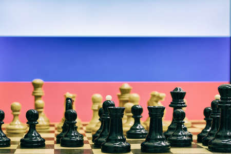 Russia flag on the background of chess with pieces on the Boardの写真素材