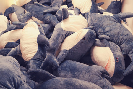 A lot of toy sharks in the store, background