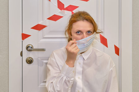 The woman removes the medical mask from her face. Concept of ending the quarantine and isolation...