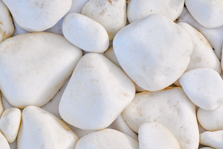 Background of roundish stone, close-up. Texture in the form of white rocks. Texture of large white...