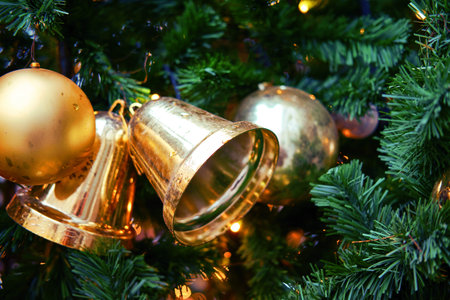Christmas tree with decoration of golden bell. New Year ornament for festive decor