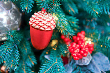 Green christmas tree with red acorn, xmas decorations on new yearの写真素材