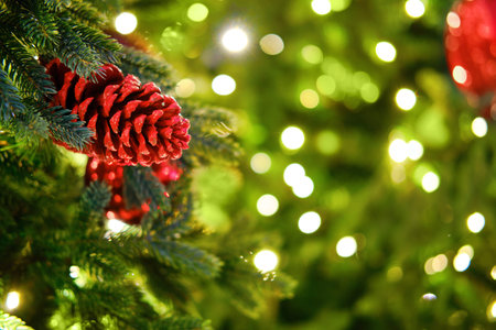 Christmas tree decorated with a natural red cone. Preparation of ornaments for the celebration of new year and Christmas, bokehの写真素材