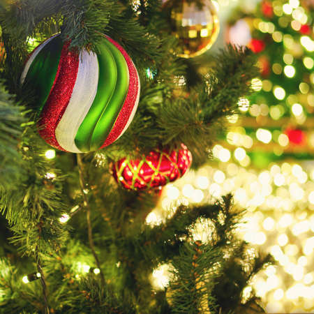 New year and xmas tree decorations with striped ball and red bauble, close-upの写真素材