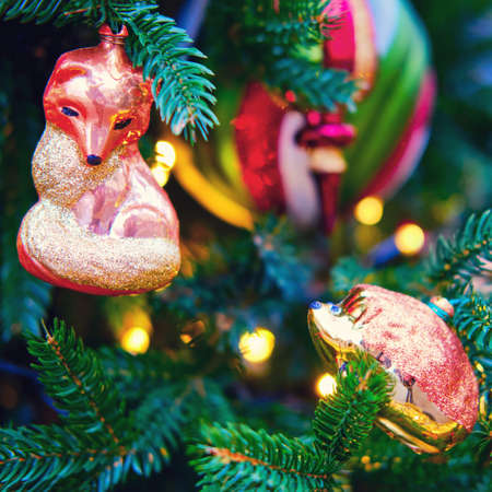 Fox and hedgehog made of glass hanging as decorations on a Christmas tree, close-upの写真素材