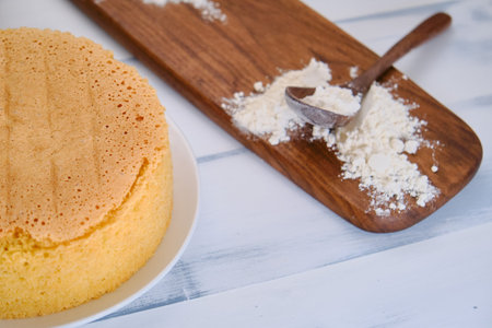 Flour on a wooden board for making sponge cake, white background