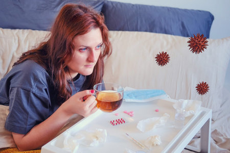 A woman with the flu drinks tea in a bed under quarantine. Collage of a woman in isolation at home...