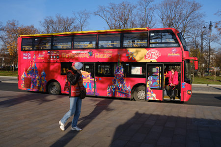 The red sightseeing bus for tourists on the streets of Moscow. Barker on a tour with a megaphone for...