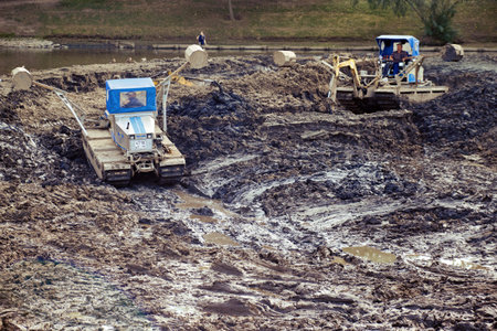 Truxor DM 5000 amphibious machines clean the drained pond from debris. Russia, Moscow, Tsaritsyno -...