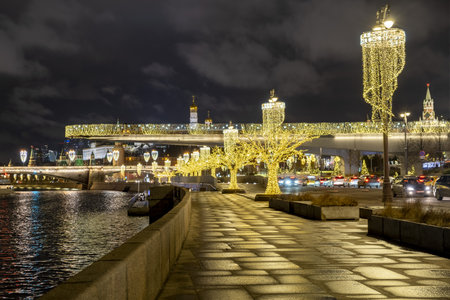 View of Zaryadye Park, soaring bridge over the Moscow river, the Kremlin and Pokrovsky Cathedral on new year and Christmas holidays in the evening - Moscow, Russia, 17 01 2020のeditorial素材