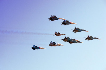 Moscow / Russia - 05 09 2014: aircraft group MiG flying in the blue sky, close-up