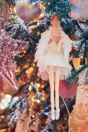 A woman with white wings as a toy for decorating a Christmas treeの写真素材