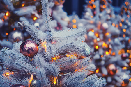 Branches of white christmas tree decorated with bauble and balls before the new year