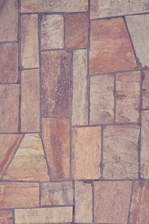 The texture of the floor is a beige tile irregular shape