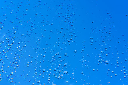 Water drops on the window after the rain, blue sky