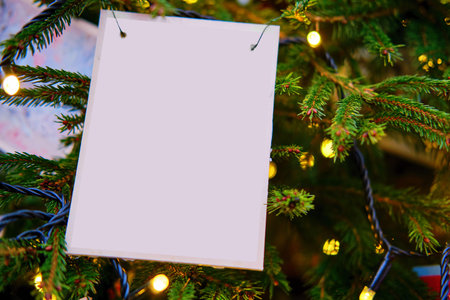 Old postcard on a Christmas tree, mockup. Garland lights and decoration for the new year, copy space