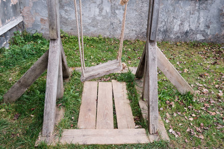 The old wooden swing on the ropes, the courtyard house