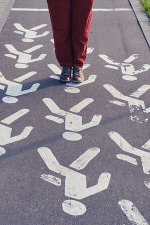 Woman stands at a pedestrian crossing, close-upの写真素材