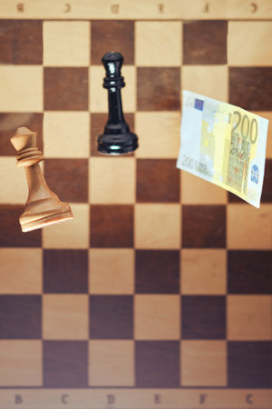Euro money and retro chess board with pieces king and queen. Concept of research problems in european economics, money and successの写真素材
