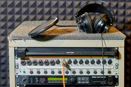 Headphones and microphone pop filter on digital equipment of a recording studio - Moscow, Russia,...