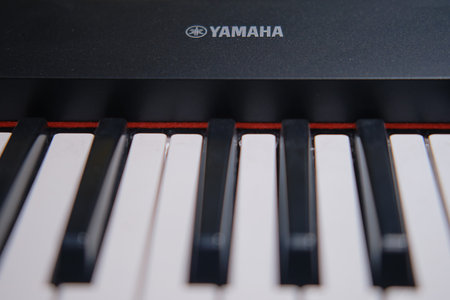 Electronic piano keys, black synthesizer Yamaha close up - Moscow, Russia, January 27, 2021のeditorial素材