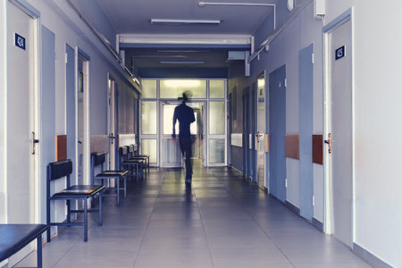 Blurred silhouette of a man passing away through the hospital hallway. The concept of problems of recovery and exit from the clinicのeditorial素材